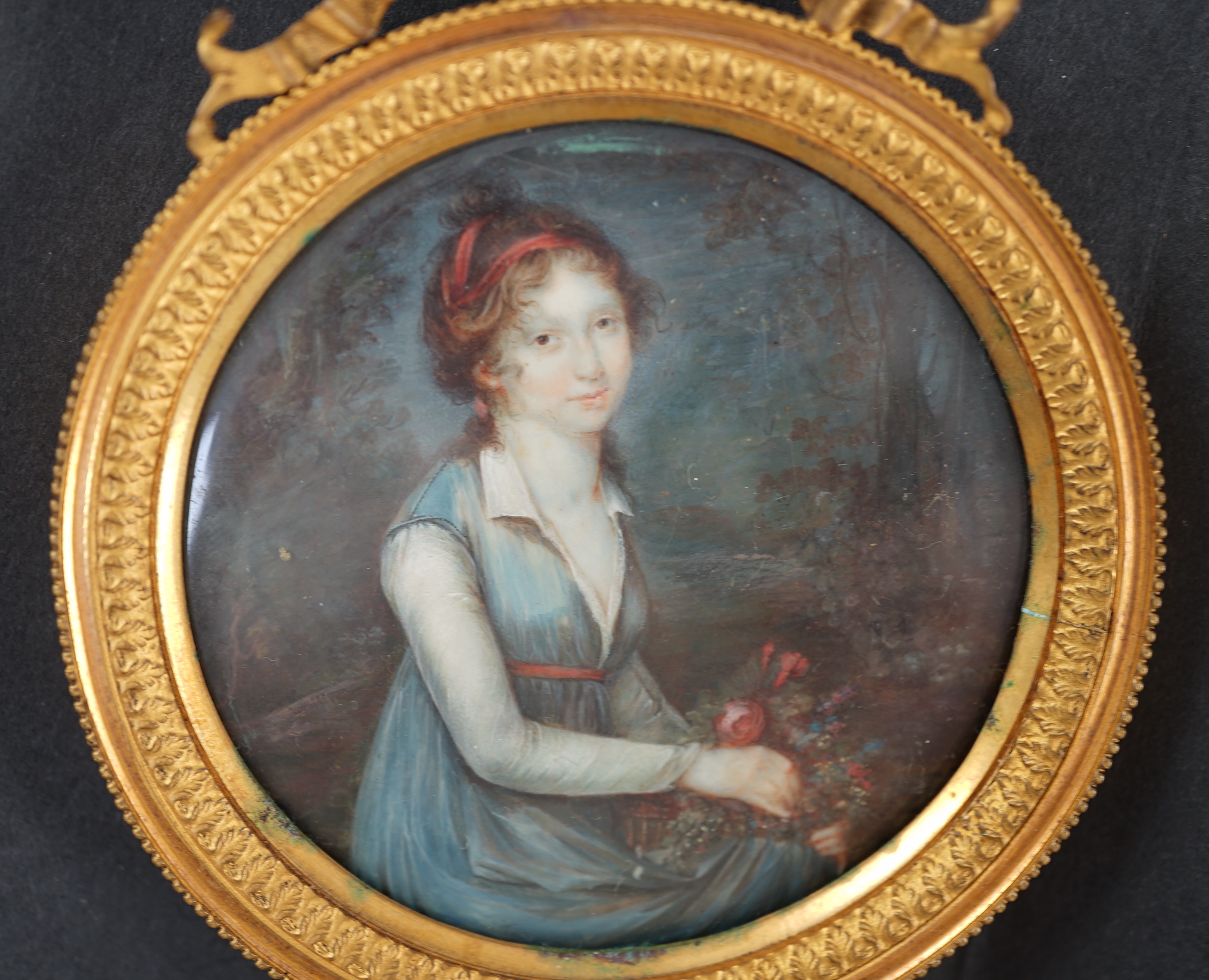 French School circa 1870, Portrait miniature of a lady seated in parkland, watercolour on ivory, tondo, 6.8cm. CITES Submission reference 8CHHM4M3